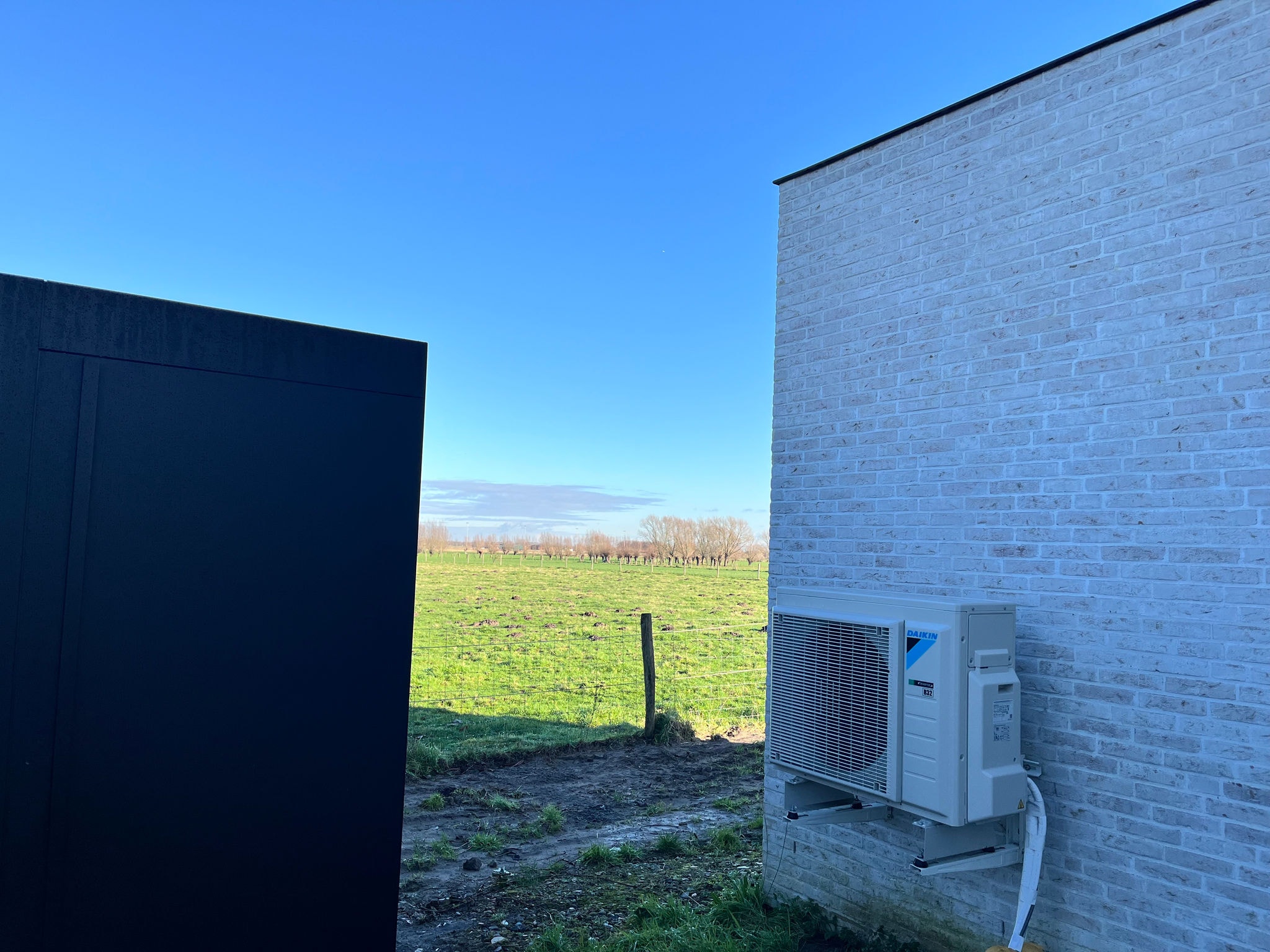 Daikin Altherma 3R outdoor unit, discreetly placed for efficient and quiet home heating